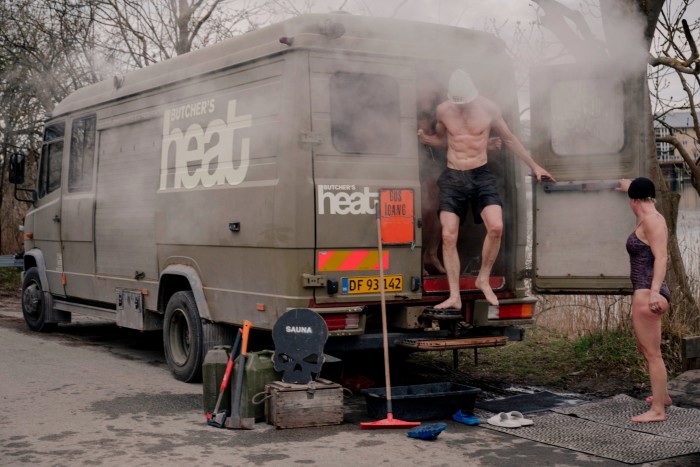 A man coming out of the back of the Butcher’s Heat sauna van, a converted ex-military vehicle