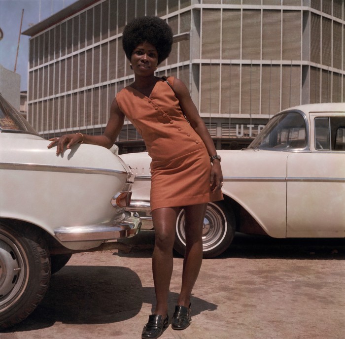 Store assistant on Station Road, Accra, 1971, by James Barnor
