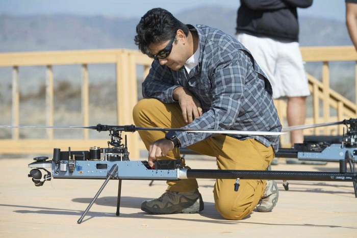 An Anduril Industries engineer checks a heli-drone before it takes off from a Marine Corps base in California 