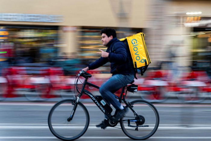 Glovo food delivery worker on a bicycle