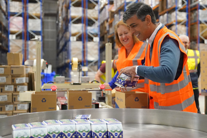 Rishi Sunak packs products with Attorney General and parliamentary candidate for Banbury, Victoria Prentis during a visit to DCS Group in Banbury