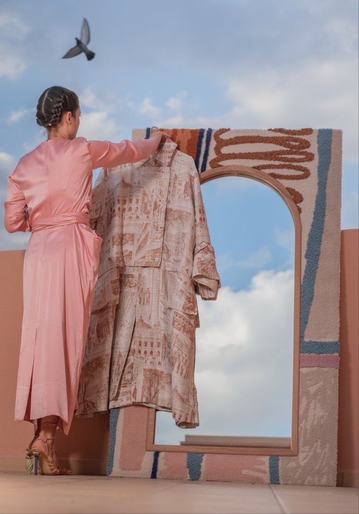 Leenaert on her roof terrace in Marrakech with her Acne Studios jacket and LRNCE Illou mirror
