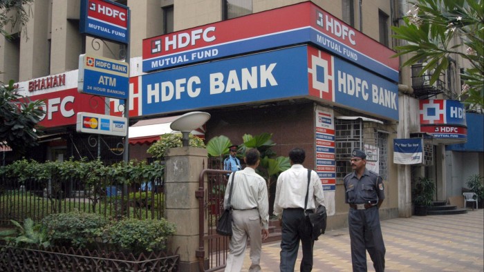 Customers enter a bank branch of the Housing Development Financing Corporation in Mumbai