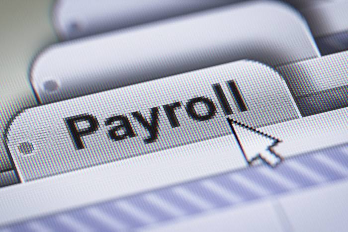 A computer mouse pointer pointing at the word ‘payroll’ on a computer screen