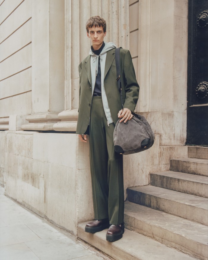 Bennett Winch suede Commuter duffel bag, £1,275. Canali wool suit, £1,490. Sunspel cotton zip-up hoodie, £185. MHL by Margaret Howell cotton jersey T-shirt, £150. Hermès leather ankle boots, £1,400