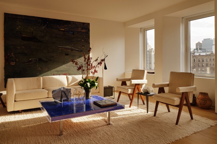 Khouri’s Yves Klein table and Pierre Jeanneret chairs, between which one of her sculptures sits on a vintage steel table