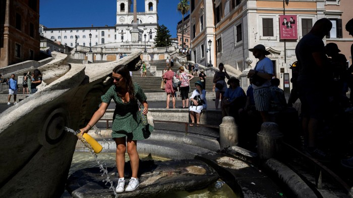 People cool off at Piazza di Spagna in Rome, Italy