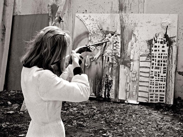 Niki de Saint Phalle during a shooting session for one of her Tirs works at Impasse Ronsin, Paris, in 1962