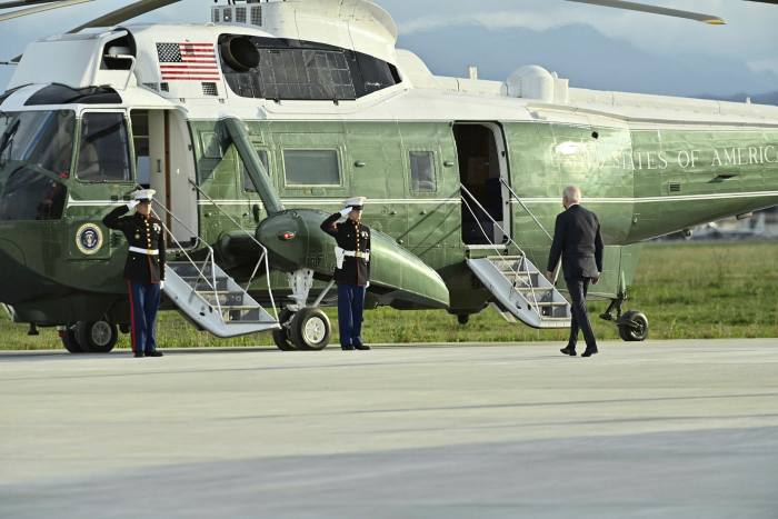 President Biden walks towards a helicopter at an airbase