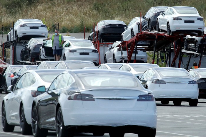 Tesla cars are loaded on to carriers in California. Encouraged by the cleaner air evident in the coronavirus lockdown, the treacle-like shift towards battery cars may pick up pace