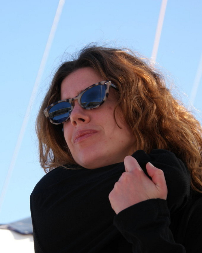 The author of this article wearing sunglasses, on the boat on which she sailed to the Tuscan Archipelago