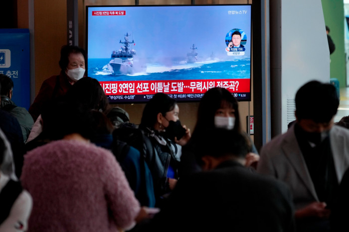 Footage of South Korean navy vessels is shown during a news programme screened at the main Seoul railway station 