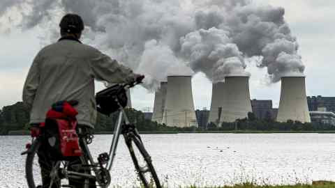 Water steam rises from the cooling towers of a brown coal power station operated by Vattenfall AG in Jaenschwalde
