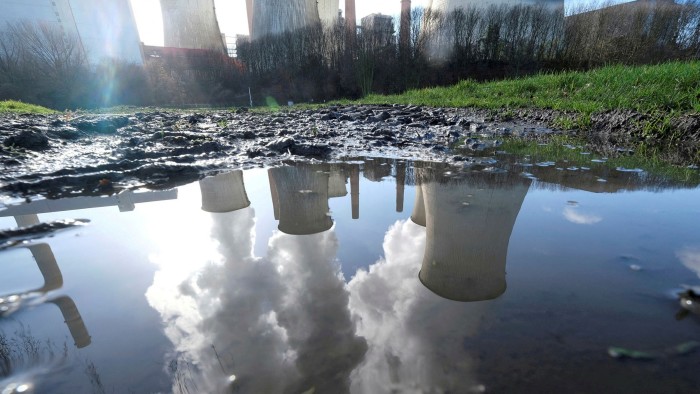 An RWE power plant reflected in a large puddle in Neurath, north-west of Cologne, Germany