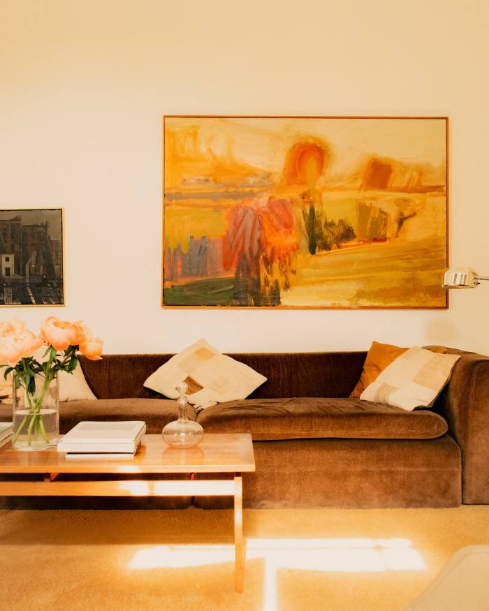The sitting room features a 1970s Italian sofa from Milan, an early painting by Bruce Lacey when still a student at the RCA (on left) and a landscape by Morley Bury (on right)