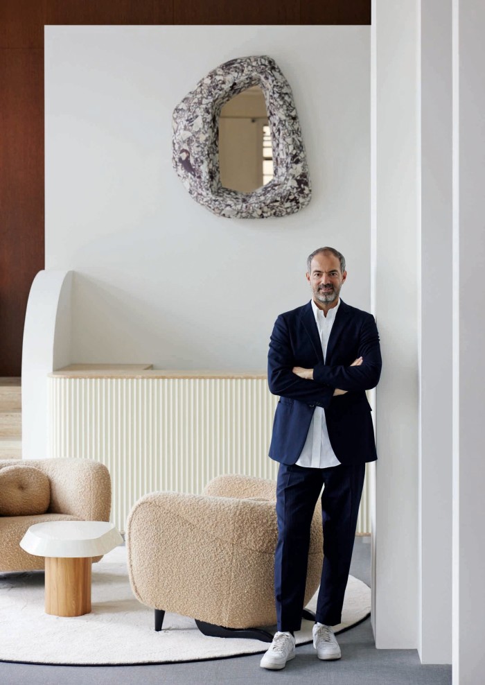 The Square Berlin co-founder Emmanuel de Bayser. Behind him are Pierre Augustin Rose Helios Marble mirror, €24,000, Minitore armchairs, €8,800 each, and Galet occasional table, €2,900