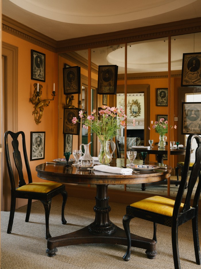 Early-20th-century chairs and a tilt-top table in the dining room