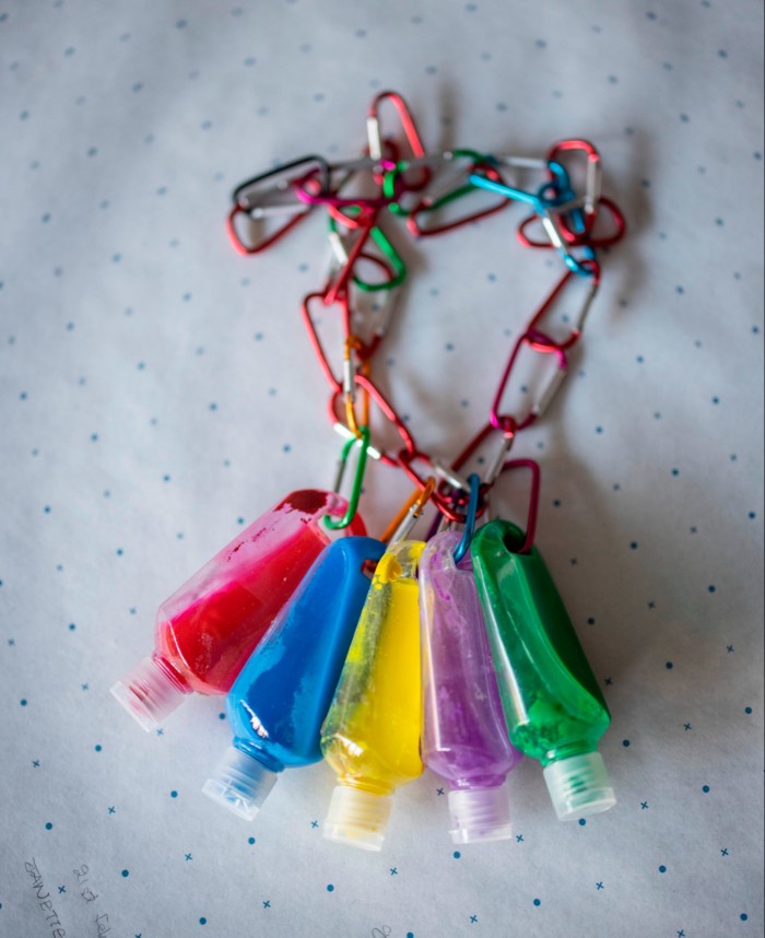 five plastic bottles hanging off the colourful metal clip