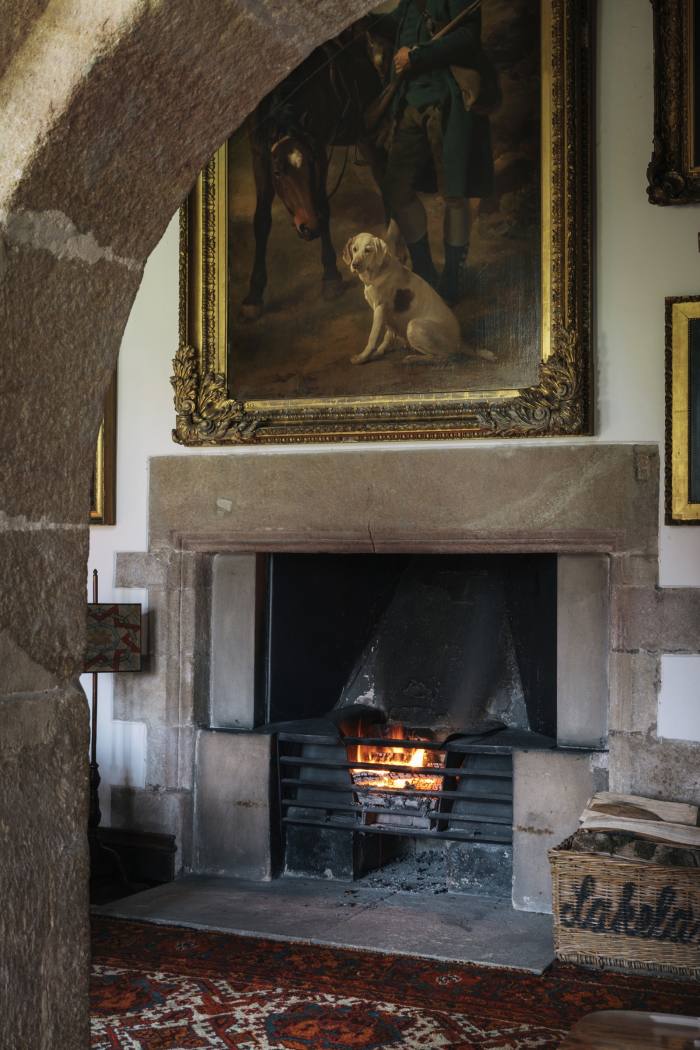 A fireplace framed by a 14th-century arch