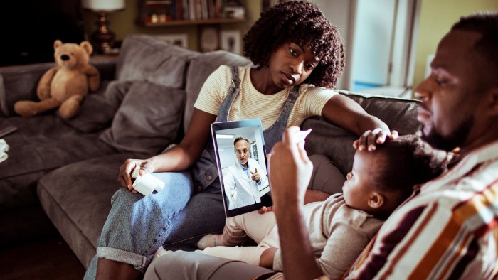 How we live now: lockdown has ended personal contact with professional advisers, from doctors to lawyers. Close-up of a young family consulting with their doctor over a digital tablet