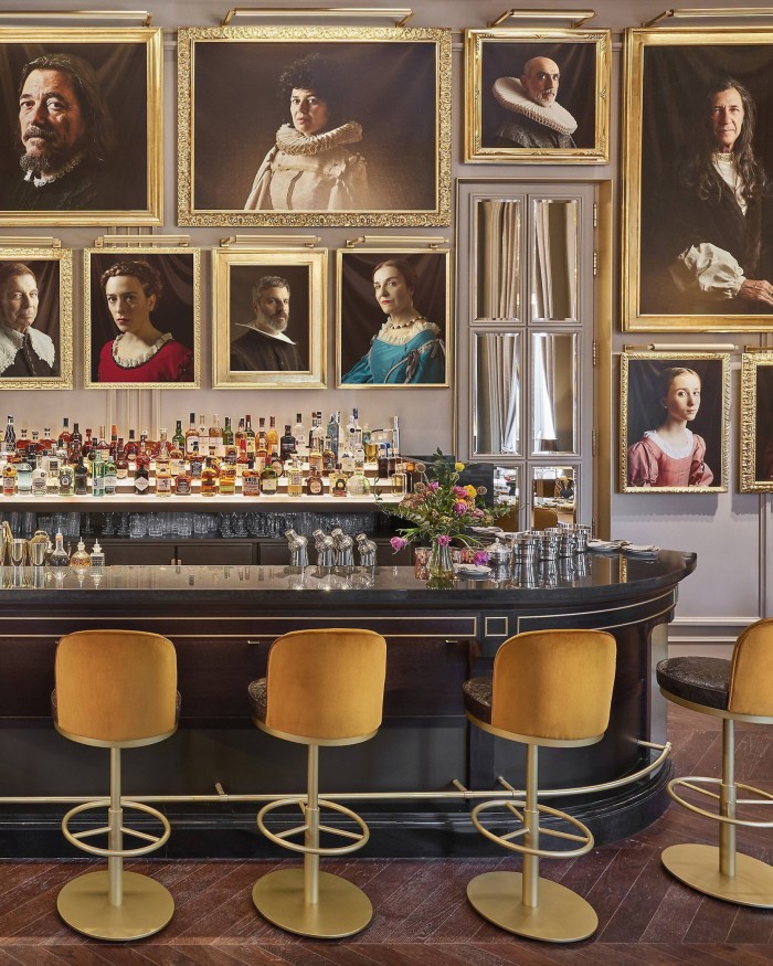Photographs of local cultural personalities made to look like the subjects of Old Master portraits in the hotel’s Pictura bar