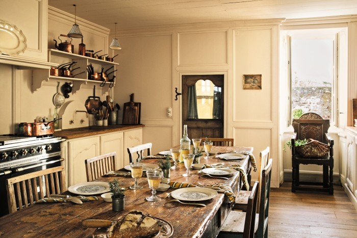The kitchen with its vintage pantry table and open shelves, painted in an off-white developed by Ressource Peintures