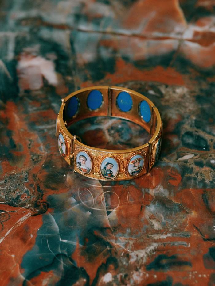 A gold and enamel cuff given to Sophia Hirsh by her Swiss grandparents. It features portraits of women in traditional Swiss dress
