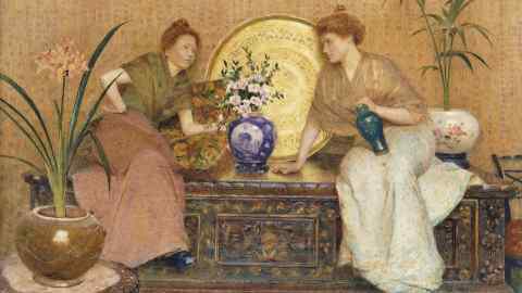 ‘Two Ladies Sitting on a Chest by a Cairo Ware Tray and a Vase of Flowers’, by Hector Caffieri (1847-1932)
