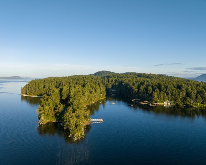 An aerial view of the tree-covered Bowen Island, surrounded by water 