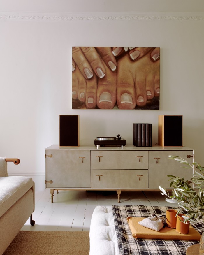 A painting by Issy Wood above the BDDW leather credenza in the living room
