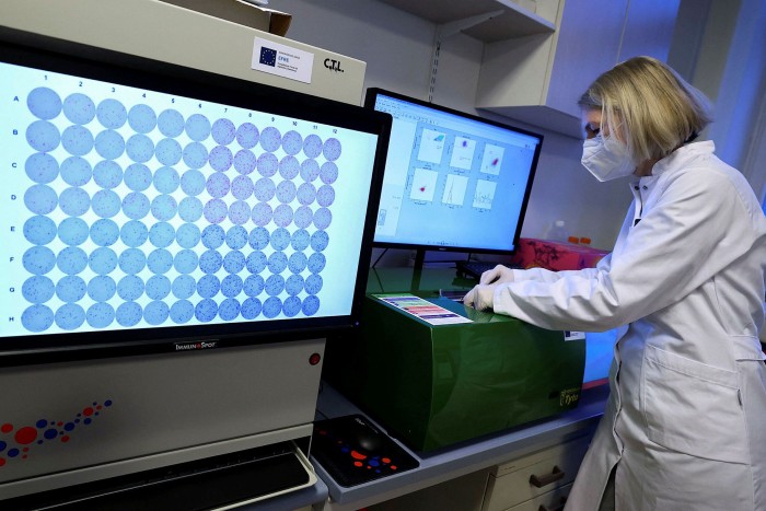 A researcher working on a cell sorter during research into long Covid in Germany