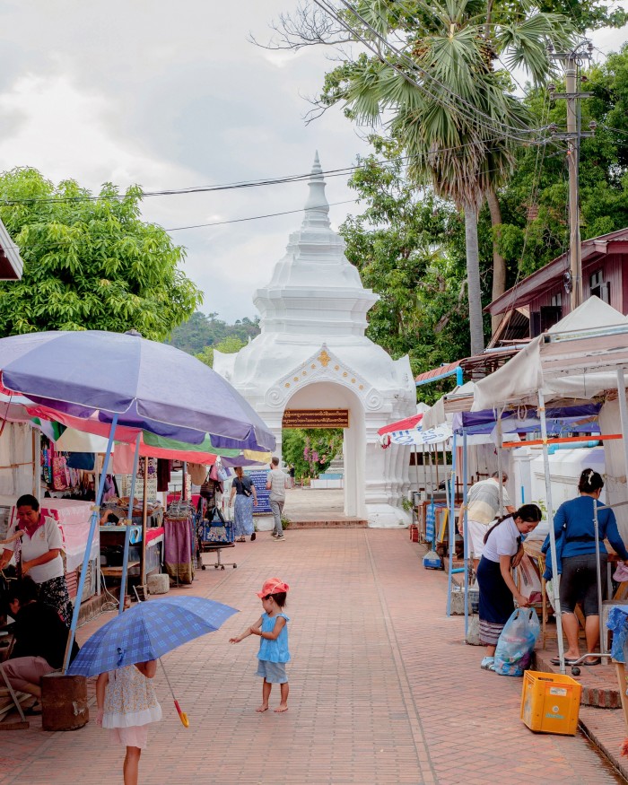 Market stalls on a path leading to Wat Xieng Thong temple