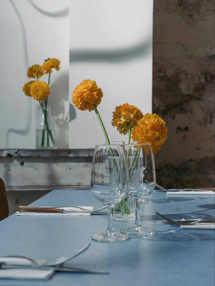 Flowers in a glass on a table in Dame Jane