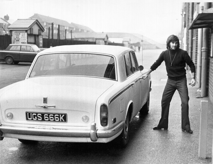 Footballer George Best with his 1972 Silver Shadow at Old Trafford