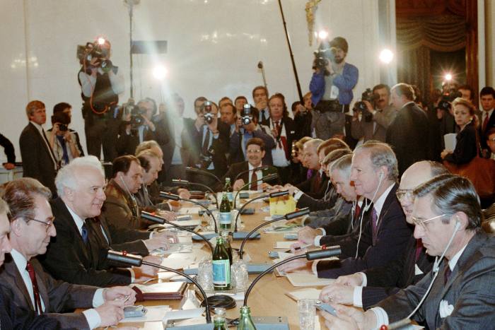Talks in the Kremlin in 1990 between Soviet foreign minister Eduard Shevardnadze (third from left) and US secretary of state James Baker (third from right). They are seated at a long table, flanked by officials in suits