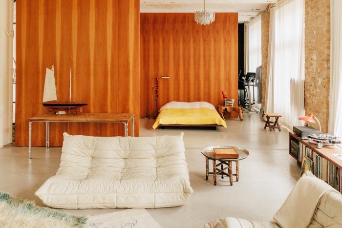 The living area and bedroom include a Ligne Roset Togo sofa and a blanket by Perelic Woolen Goods