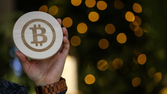 The logo of bitcoin engraved on a piece of wood in Arnhem, Netherlands