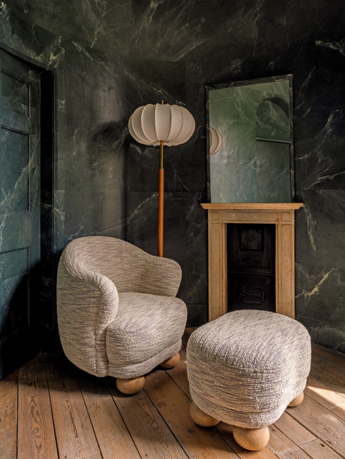 The Rupert armchair, £8,160, and Rupert ottoman, £3,600, in front of the Pumpkin lamp, £18,000