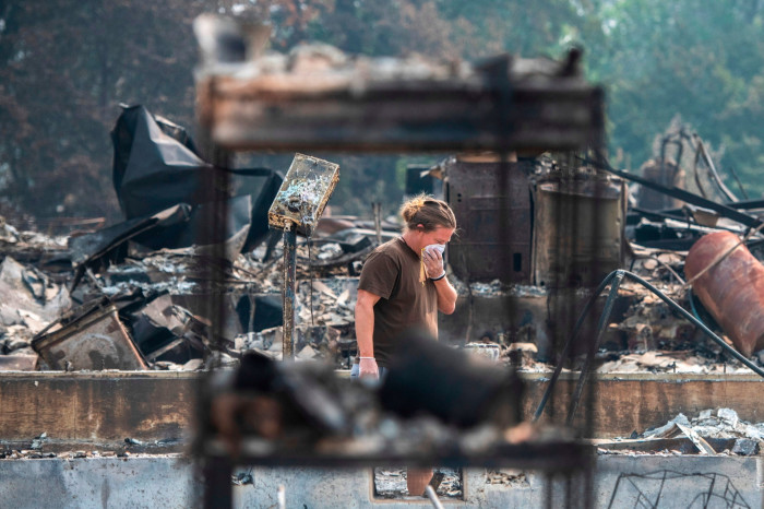A man checks the remnants of his house for anything salvageable in Talent, Oregon in September 2020