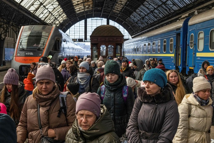 Displaced Ukrainians arrive in a train station in the western city of Lviv