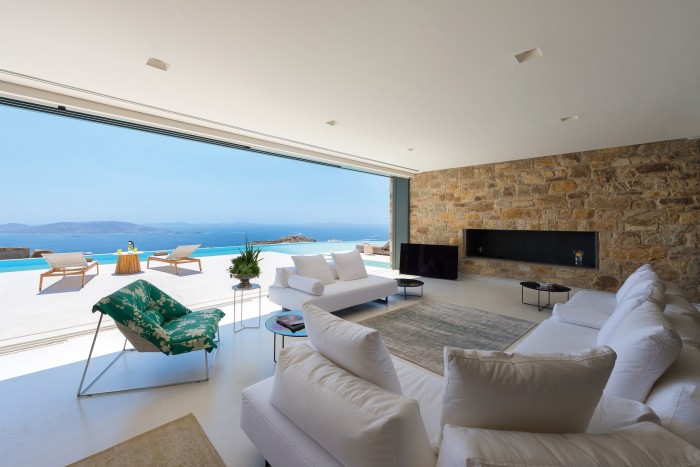 The living area at Elysium villa leads to a patio and pool