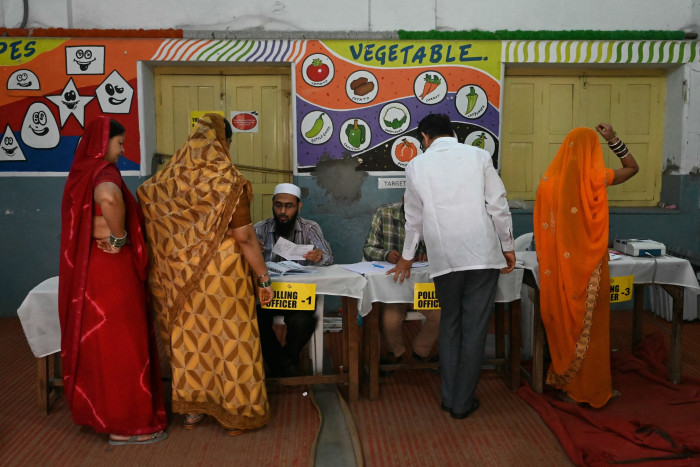 Voters arrive at a polling station in Telangana’s elections in Hyderabad