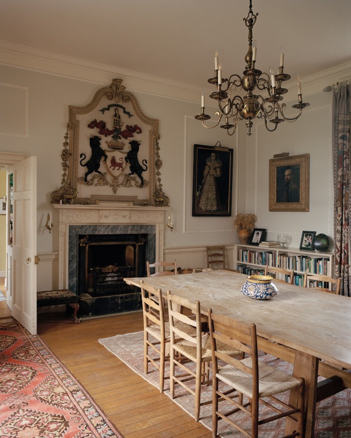 The Hall is used as the family dining room, with an oak table by Arts and Crafts architect Philip Webb. The Ogilvy coat of arms is set in relief above the fireplace 