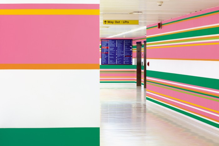 Pink, green and yellow stripes on the walls of a hospital
