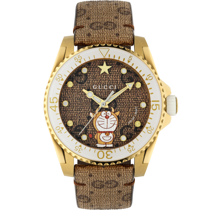 Doraemon x Gucci Dive watch: canvas dial with Doraemon print in yellow-gold case, £1,150. (Doraemon, here wearing ox horns, is the hero of a Japanese manga series – a cat-type robot from the 22nd century)