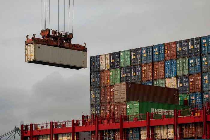A ship is loaded with containers in the Kwai Tsing Terminals in Hong Kong