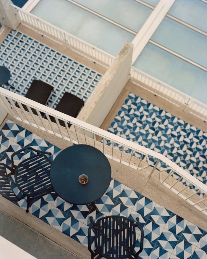 A cascade of balconies, each with a unique pattern of tiles that is echoed inside the room