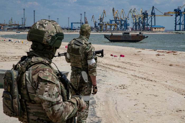 Russian servicemen prepare to demine Peschnaya beach near the cargo sea port of Mariupol, Ukraine, on June 12