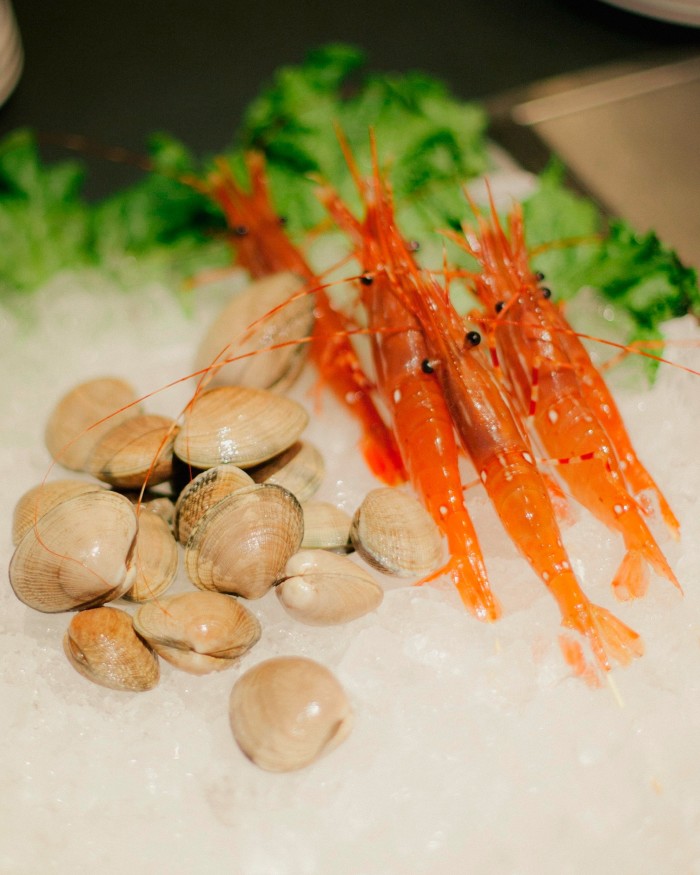 Local clams and British Columbia spot prawns on a bed of ice