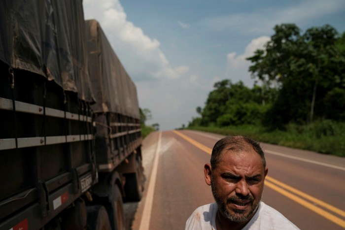 A driver hauling farm produce breaks his journey near Rurópolis, Pará state. Brazil’s agricultural sector relies on tens of thousands of trucks to cover the vast distances between the country’s interior and its ports